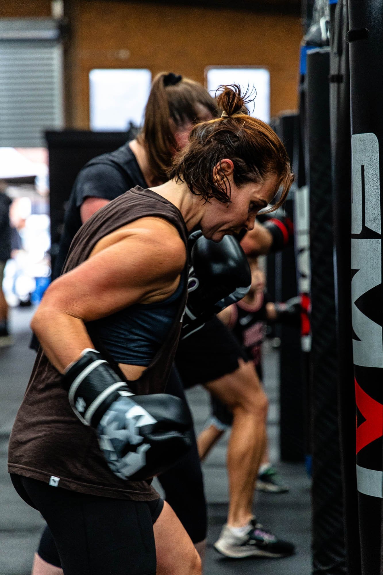 Members working the heavy bags in a Brother Boxing class