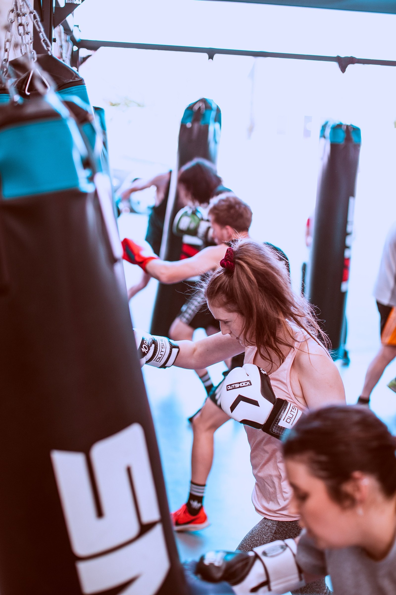Members training on the bags in a busy class