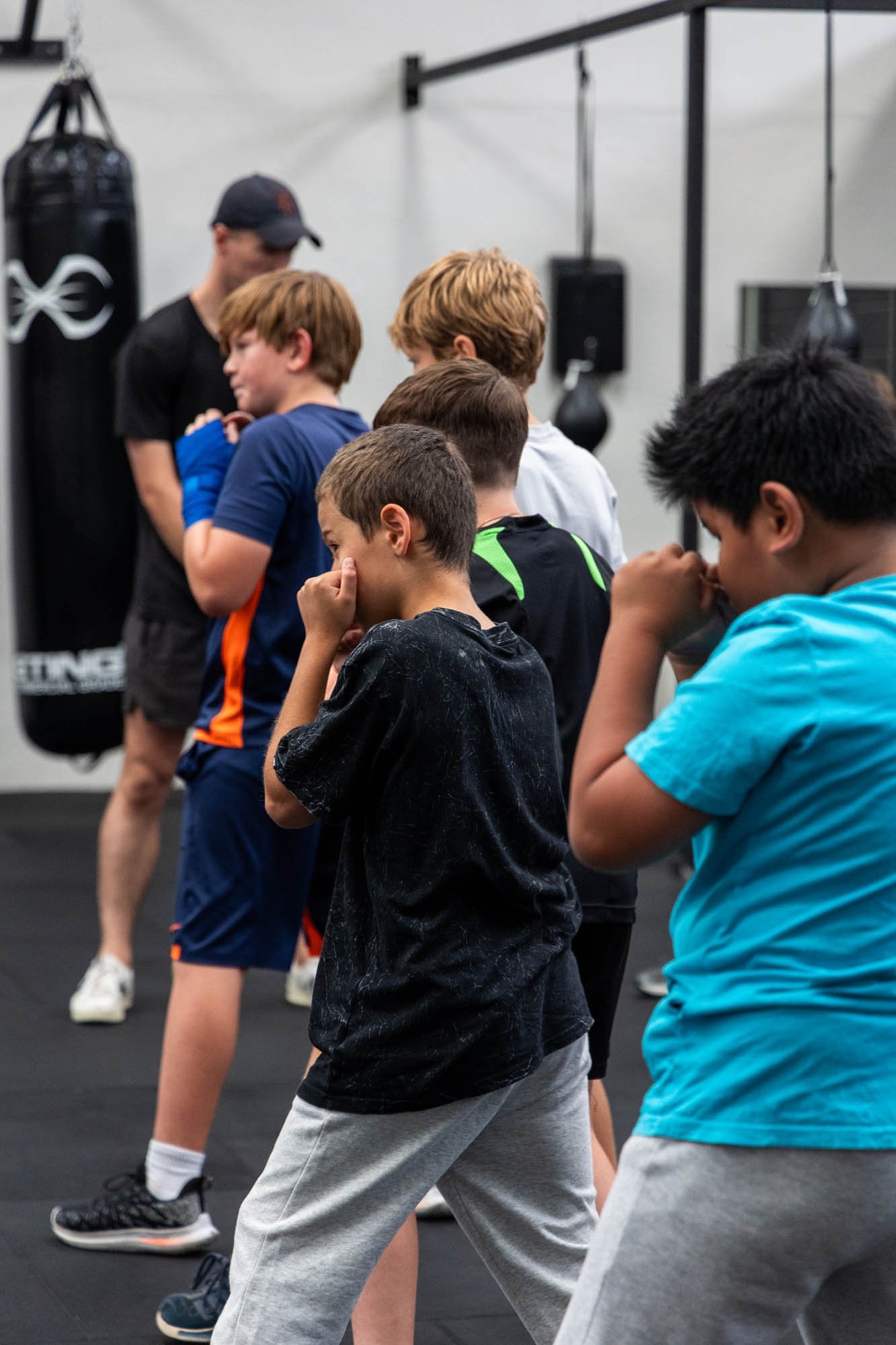 Kids learning their guard in a youth boxing class